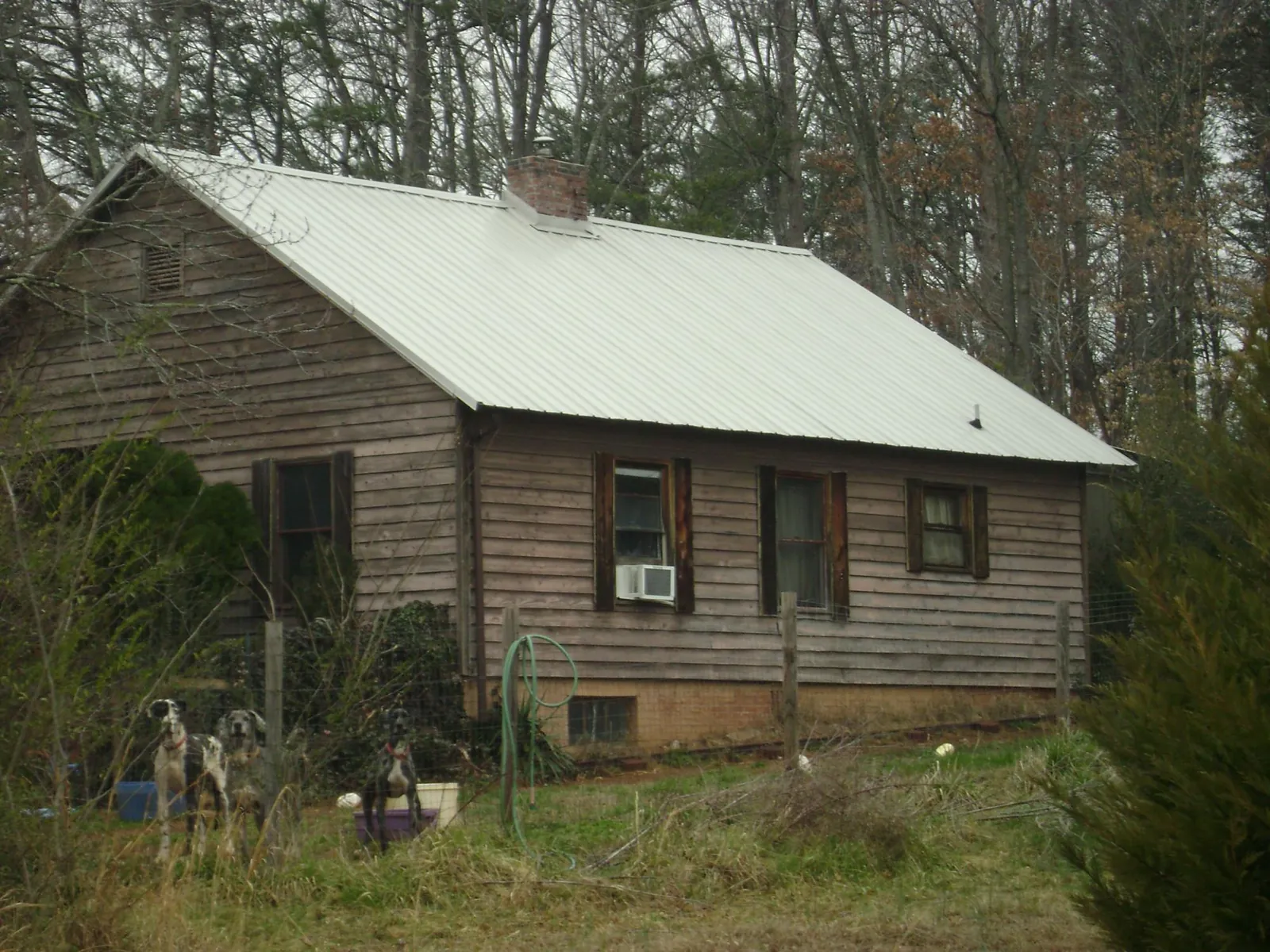 White metal roof on an old wood sided farmhouse, from a Metal Roof Installation job in Jarratt